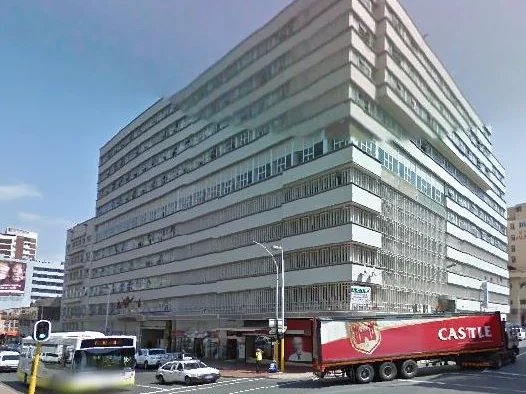 Exterior of a large white multi-storey building on a city street corner